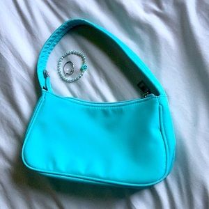 A teal mini bag never been use